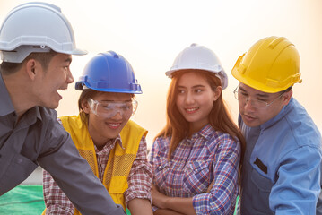 Engineers coworker discuss construction projects in workplace construction site. group of technician architect planning with blueprint and construction tools