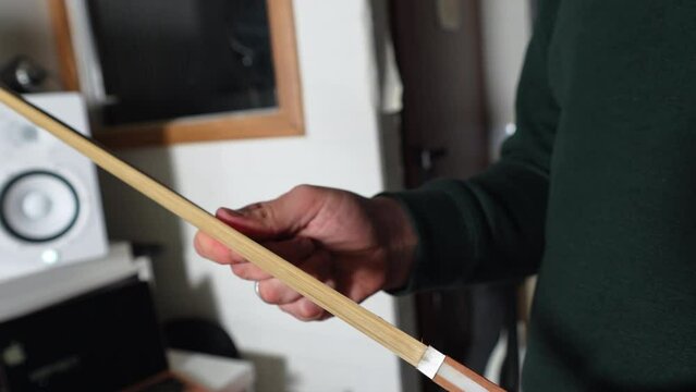 Man holding a violin bow. High quality 4k footage