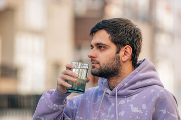 young man drinking glass of water