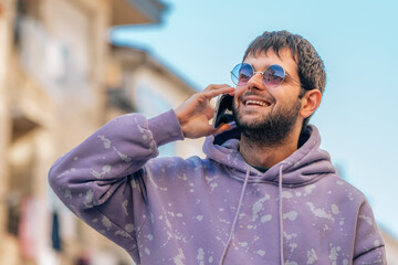 young man on the street talking on mobile phone