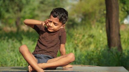 kids doing yoga pose in the park outdoor. Healthy life style concept.