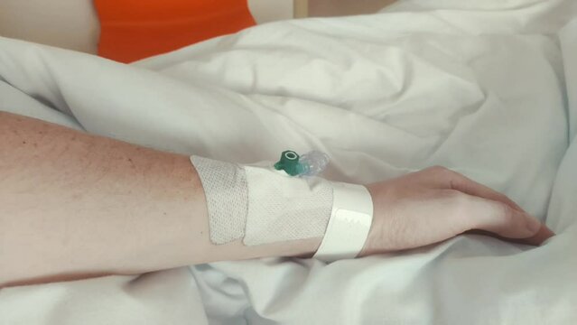 Peripheral venous catheter in mam hand.