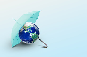 Umbrella covering Earth globe on light background, protect our planet earth and save our World environmental concept , Elements of this image furnished by NASA