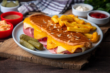 Delicious looking hot sandwich - toast. Sandwich with mixed toast, cheddar cheese and salami.