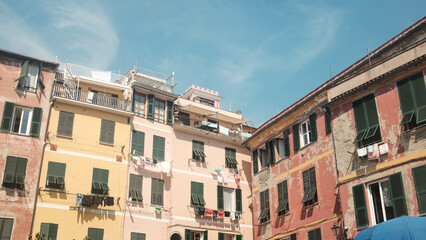 Colorful Italian Buildings with Pink Tints Under a Blue Sky, Capturing Summer Vibes
