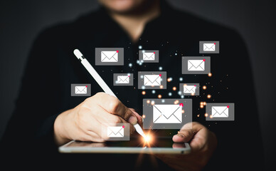 Businessman holding tablet and touching with virtual white newsletter for electronic mail or E-mail with notification alert concept
