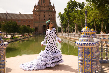 Flamenco dancer woman, beautiful brunette teenager dressed in typical costume with ruffles and...