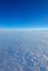 Landscape above the clouds seen from the plane