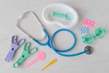 Children's medical instruments. The concept of a pediatrician. Pediatrics. Toy medical devices on a white background. Children play professional doctor. Choice of profession. Get vaccinated