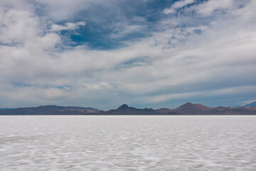 Scenic view of Bonneville Salt Flats in western Utah with Silver Island Mountains peaks in the background, Wendover, USA, America. Densely packed salt pan and natural landscape near Salt Lake City