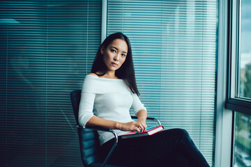 Female entrepreneur sitting on chair in workplace