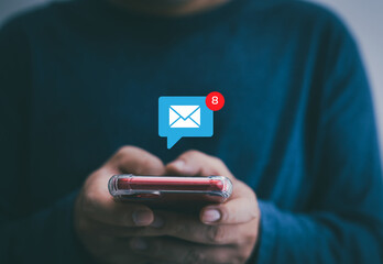 Notification concept, businessman holding smartphone touch white newsletter like e-mail