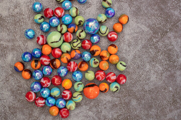 Glass colored marble balls , glass balls isolated on gray background . Children's play equipment.