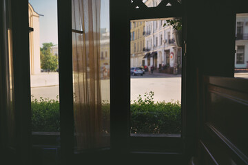 Open wooden window frame of cozy cafe for venting in hot time. Airflow penetrate through window indoor of restaurant for room cooling.