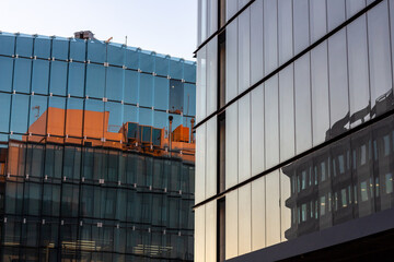 Composition of two modern buildings in Madrid and their reflections, producing a nice contrast with balance and symmetry at sunset.