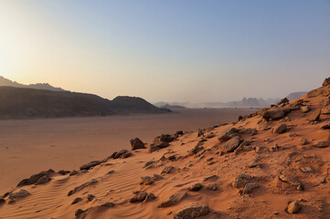roks and red sand in wadi rum desert at sunset