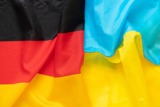 Two Flags Of Germany And Ukraine As A Background, Unification And Union Of Two Countries