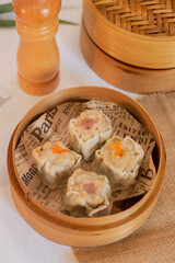 steamed four flavor dumpling dimsum in traditional bamboo steamer. Close up food photography