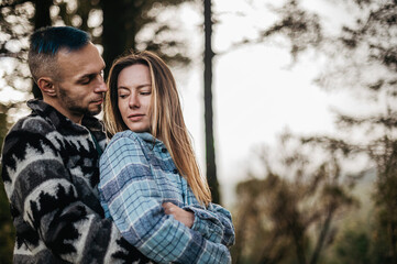 Couple embracing in an autumn park surrounded by the beauty of the fall season