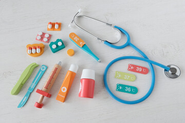 Medic first aid kit, children's medical tools on a light background.