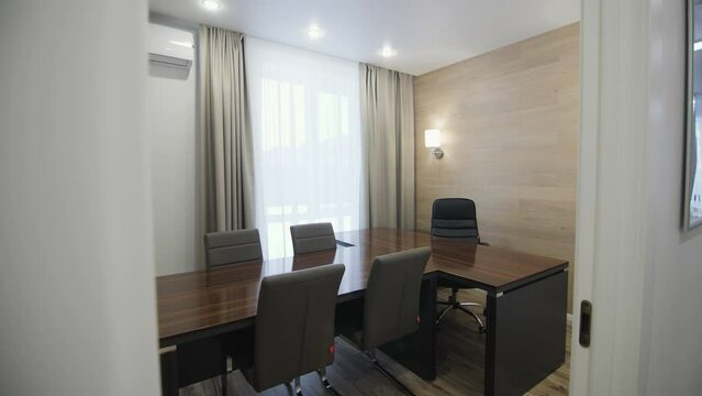Equipped home office for important meetings in luxurious apartment. Conference room made in brown and grey shades of contemporary style