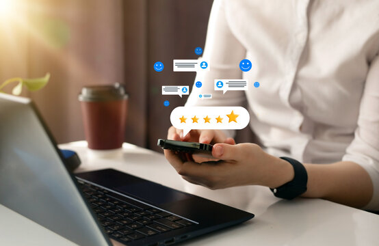 Concept of satisfaction, quality and performance. Woman who gives leave feedback on the bought product with gold five star rating feedback on virtual sreen. Customer review satisfaction feedback.