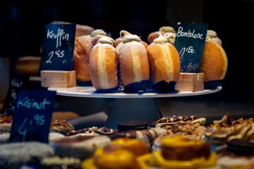 A display of cakes and sweet treats in a patisserie