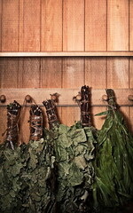Grungy Sauna Accessories. Gloomy Birch Brooms. Background Photo for Design or Banner. Wooden Bathhouse Backdrop