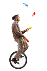 Senior man riding a unicycle and juggling © Ljupco Smokovski