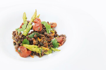 Delicious dish of lentils with tomatoes and asparagus