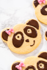 Panda shaped shortbread cookies with chocolate icing