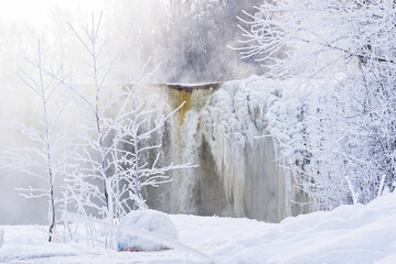 Frozen small mountain waterfall close up. Frozen Jagala Falls, Estonia. small river waterfall frozen in winter.
