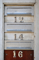 Close Up of Metal Mail Boxes with Numbers  '12-14 and 16' 