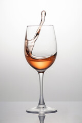Splash of rose wine in glass, frozen motion