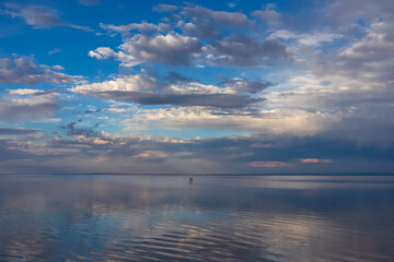 Scenic view of beautiful water reflections in lake of Bonneville Salt Flats at sunset, Wendover, Western Utah, USA, America. Dreamy clouds mirroring on the water surface creating romantic atmosphere