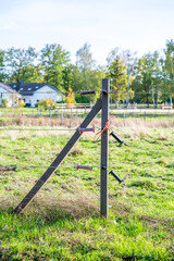 Electric fence at a farm during summertime, horse paddock in the background