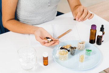 Nutritionist is writing prescription for biologically active supplements omega and zinc pills, antioxidants from aging, lecithin and adaptogen.