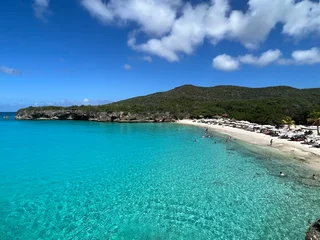 Foto op Canvas Grote Knip beach view of crystal clear blue green water in the carribean with a blue sky back ground. Curacao West Punt © WeWander