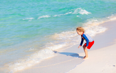 Kids playing on beach. Children play at sea.