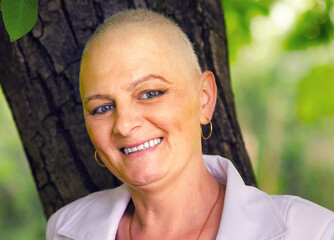 Happy woman cancer survivor in summer nature	