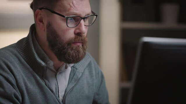 Thoughtful bearded man have doubts working with computer, focused mature man searching solution