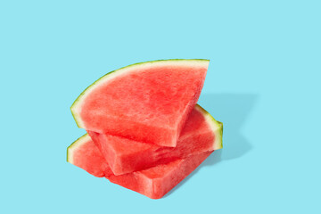 Cut watermelon on blue pastel background
