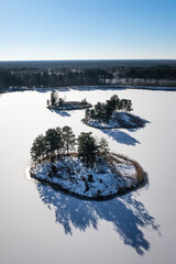 Islands on a snow-covered lake. Islands on a frozen lake. 
