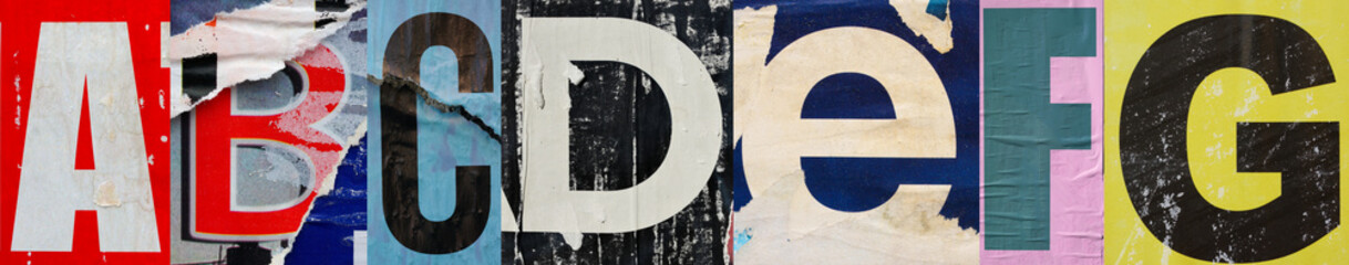 Collage of ABCDEFG ripped torn advertisement street posters grunge creased crumpled paper texture...