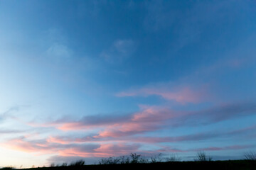 evening sky at blue hours with pink illuminated clouds