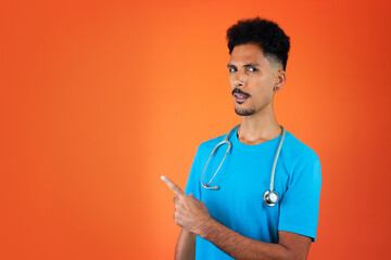 Doctor or Veterinarian Isolated. Black Young Doctor Medical Resident With Stethoscope on Orange Background.