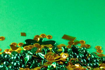 Image of green and gold jewellery and copy space on green background