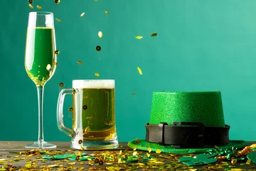 Fotobehang Image of beer and champagne glasses, green hat and copy space on green background © vectorfusionart