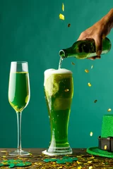 Gordijnen Image of beer and champagne glasses, green hat and copy space on green background © vectorfusionart