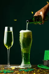 Gordijnen Image of beer and champagne glasses, green hat and copy space on green background © vectorfusionart